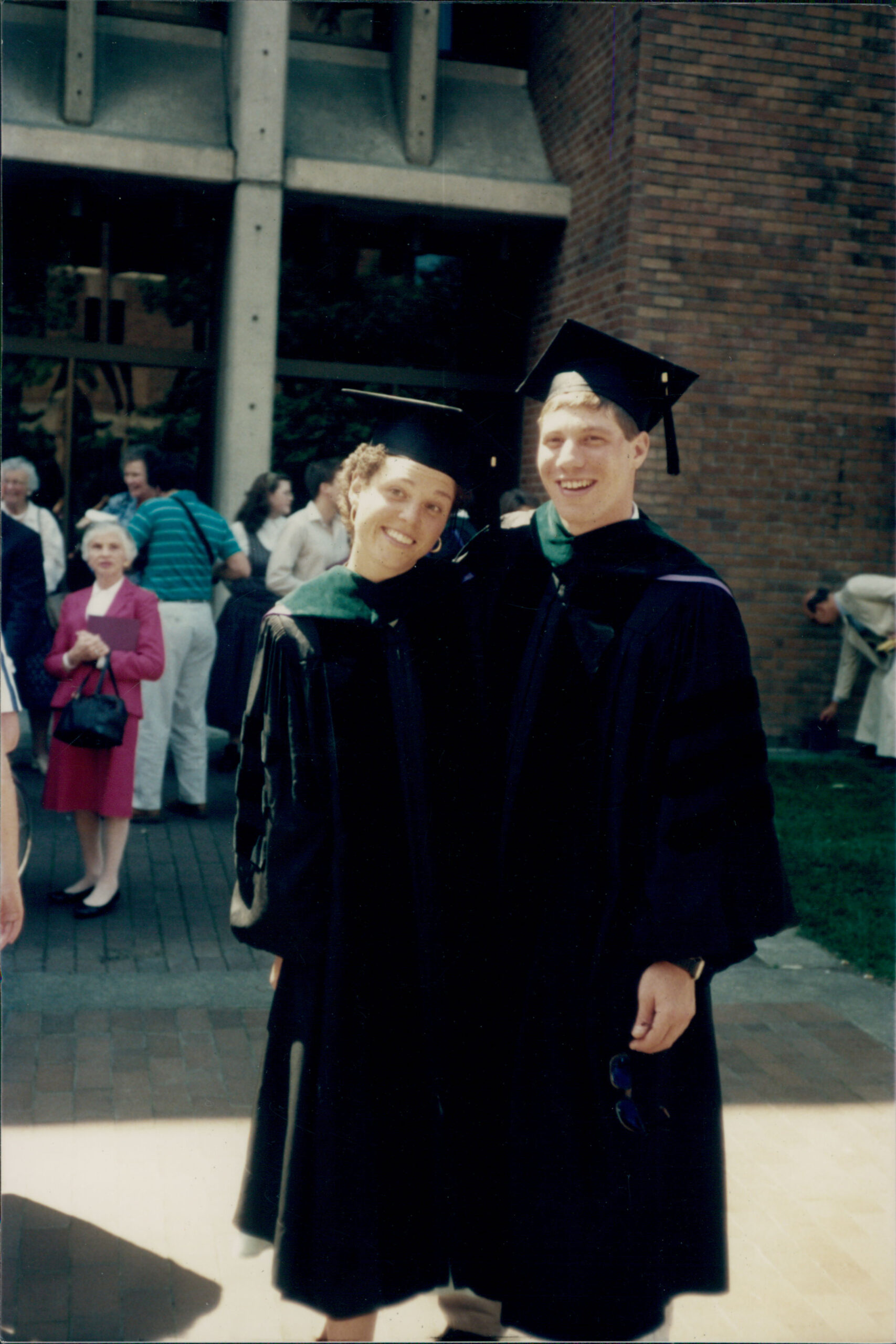 Photo of Al and Monica in graduation robes and caps.